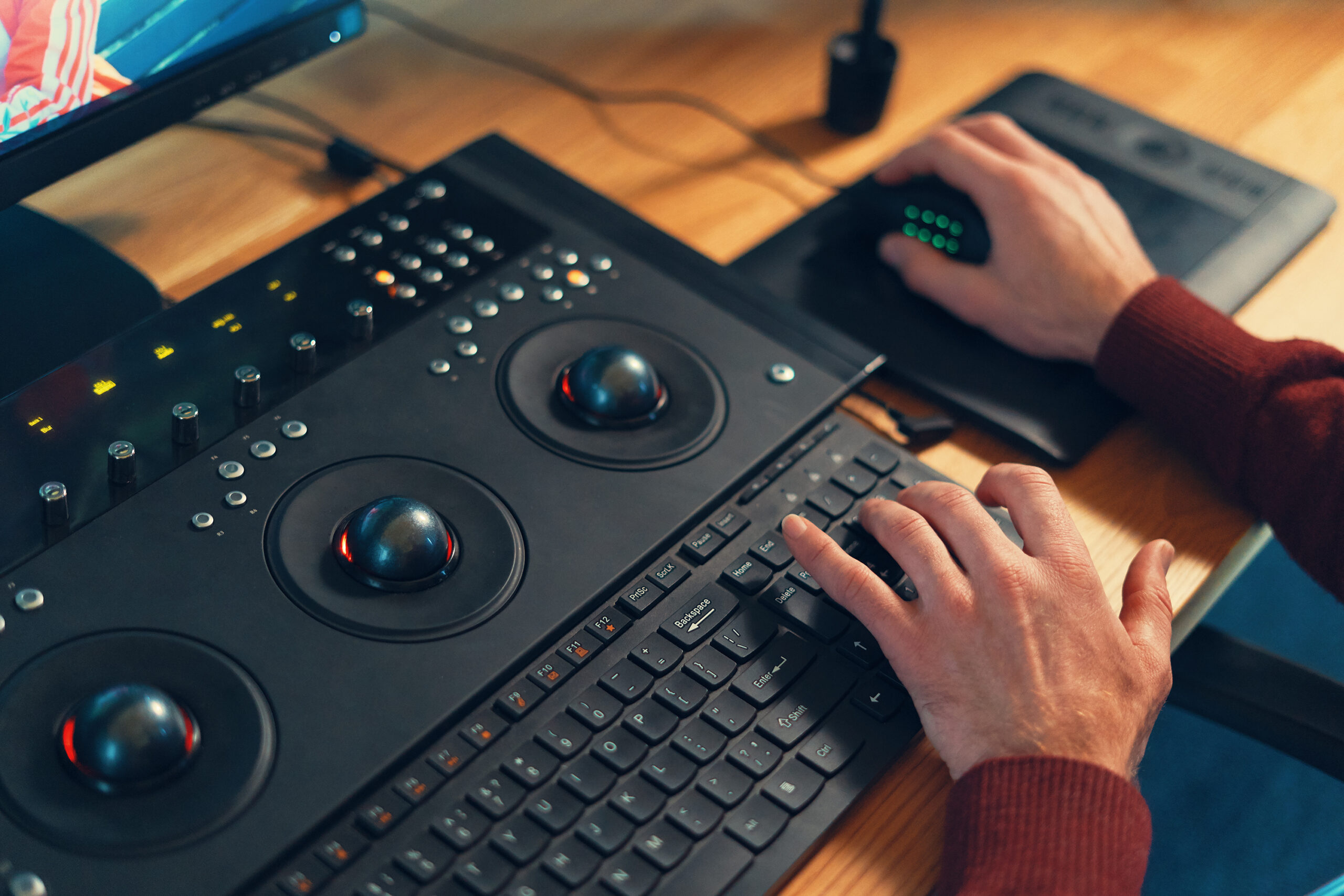 Video editor hands adjusting color or sound on working console machine in the post production stage.